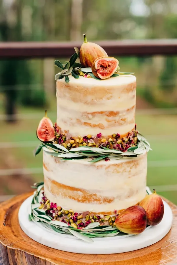 Boho naked baby shower cake with figs, olive branches and dried florals