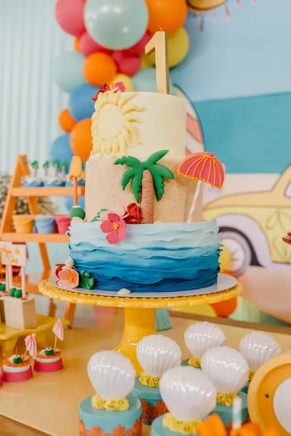 Tropical travel-themed farewell cake with a fondant palm tree, sun and ocean waves