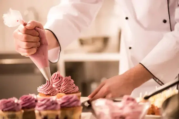 Piping cupcakes — Namz Bake House kitchen