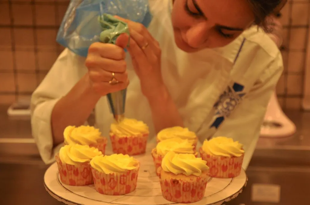 Sana Nair piping cupcakes — early days in the kitchen